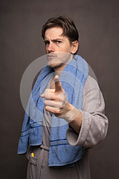 Man with bath towel on grey background