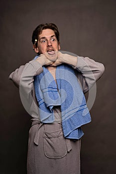 Man with bath towel on grey background