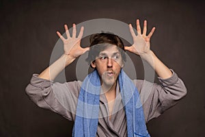 Man with bath towel on grey background