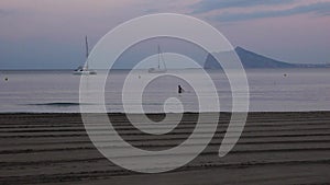 Man bathes on the beach in Calpe, Spain