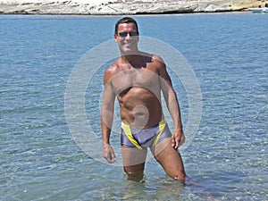 Man in bathing suit standing in tropical water