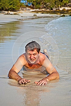 Man in bathingsuit lying at
