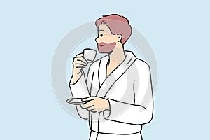 Man in bathrobe drinks coffee enjoying hot tart drink after waking up in morning.