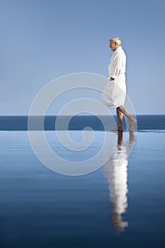 Man in bathrobe by the pool