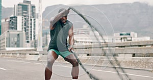 Man, battle ropes and fitness in city for speed workout or health performance for muscle, sport or exercise. Black