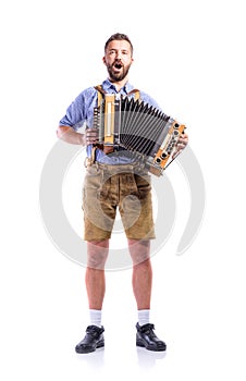 Man in bavarian clothes playing accordion and singing. Oktoberfe