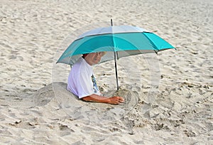 MAN ON BEACH IN BALI WITH UMBRELLA