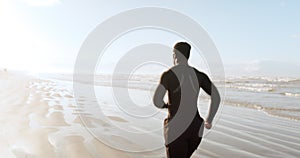 Man, beach and running in fitness, exercise or cardio workout for outdoor training or motivation. Rear view of active