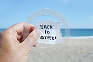 Man on the beach and text back to work in a note
