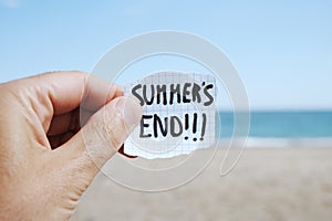 Man on the beach and text summers end in a note