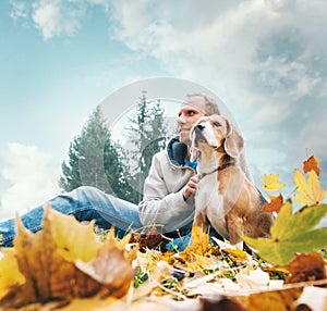 Man with beagle on autumn view landscape