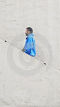 man with a beard against a white wall