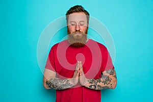 Man with beard asks to be forgiven and prays