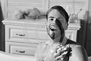 Man with beard in bathtub laughing wide