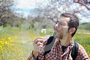 Man with Beard Blowing a Dandelion