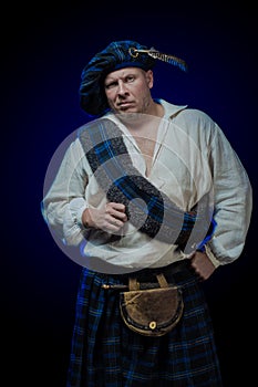 Man with a beard in a blue checkered Scottish costume