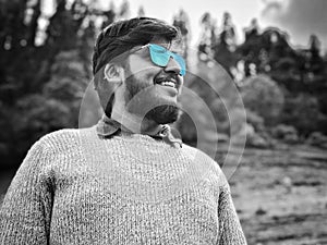 Man with beard and blue shaded sunglasses