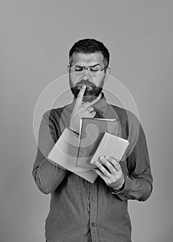 Man with beard and books. Notebooks in blue color