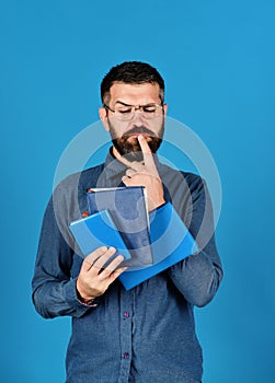 Man with beard and books. Notebooks in blue color