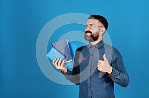 Man with beard and books. Professor with smiling face expression