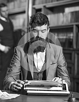 Man with beard and busy face sit in library