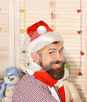 Man with beard in checkered shirt smiles widely