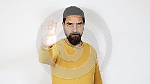 Man with beard doing stop hand sign gesture. Denying, rejecting, disagree.
