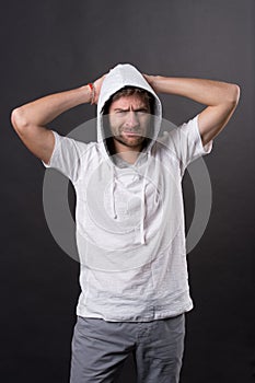 Man with beard frown in hood. Bearded man wear casual sweatshirt. Fashion model in hoodie tshirt. Active lifestyle and