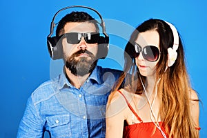 Man with beard and girl sing on blue background.