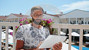 Man with beard and glasses uses tablet PC