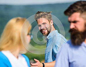 Man with beard jealous aggressive because girlfriend interested in handsome passerby. Husband strictly watching his wife