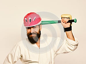 Man with beard in kimono and pink helmet on white background. MMA sports concept. Combat master gets ready to fight