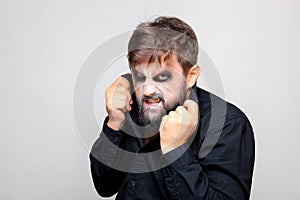 man with a beard and makeup for Halloween grimaced