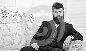 Man with beard and mustache wearing classic suit, stylish fashionable outfit. Masculinity concept. Macho attractive and