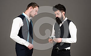 Man with beard pay to macho with measuring tape.