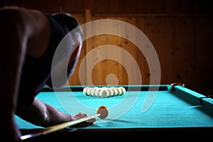 A man with a beard plays a big billiard. Party in a 12-foot pool