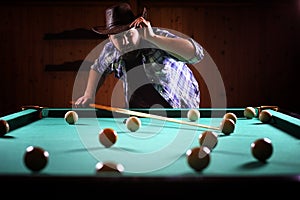 A man with a beard plays a big billiard. Party in a 12-foot pool