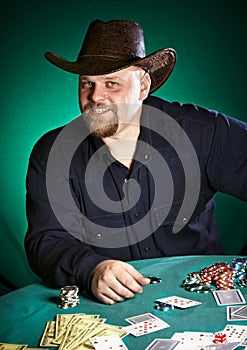 Man with a beard plays poker