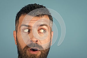 Man with beard on scared face on blue background