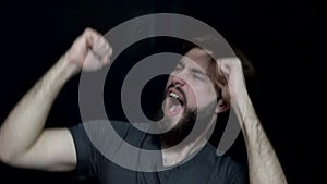 Man with beard shouting and dancing. Bearded man to madness happy and waving his hands dancing. Human emotions