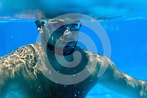Man with Beard Underwater swimming pool Young beard man with glasses Underwater