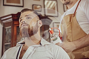 Man with beard uses the services of a barber