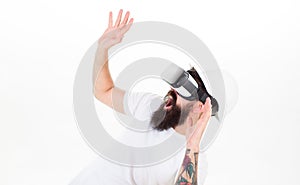 Man with beard in VR glasses and helmet, white background. Virtual reality concept. Hipster on shouting scared face use