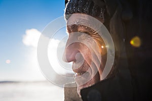 Man with a beard wearing a cap polar explorer a manly strong brutal on the background sky with white clouds wallpaper