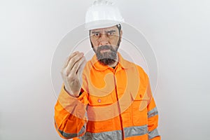 Man with beard wearing worker uniform and hardhat doing italian gesture with hand and fingers