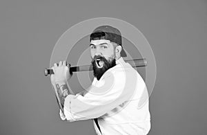 Man with beard in white kimono and green cap on blue background. Gangster gets ready to fight. Violence and bullying