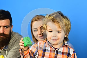 Man with beard, woman and boy play on blue background.