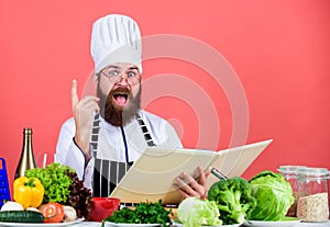 Man bearded chef cooking food. Culinary arts concept. Amateur cook read book recipes. Man learn recipe. Try something