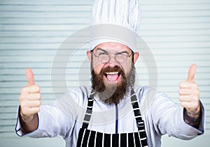 Man bearded chef getting ready cooking delicious dish. Chef at work starting shift. Guy in professional uniform ready