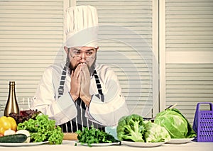 Man bearded chef getting ready cooking delicious dish. Chef at work starting shift. Guy in professional uniform ready